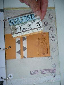 A manilla envelope that has been aged and stamped. The two paper bands hold the game card in place. I can glue stuff to the back of the game card.