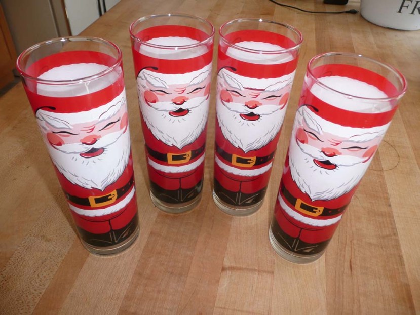 Four adorable vintage Santa glasses.